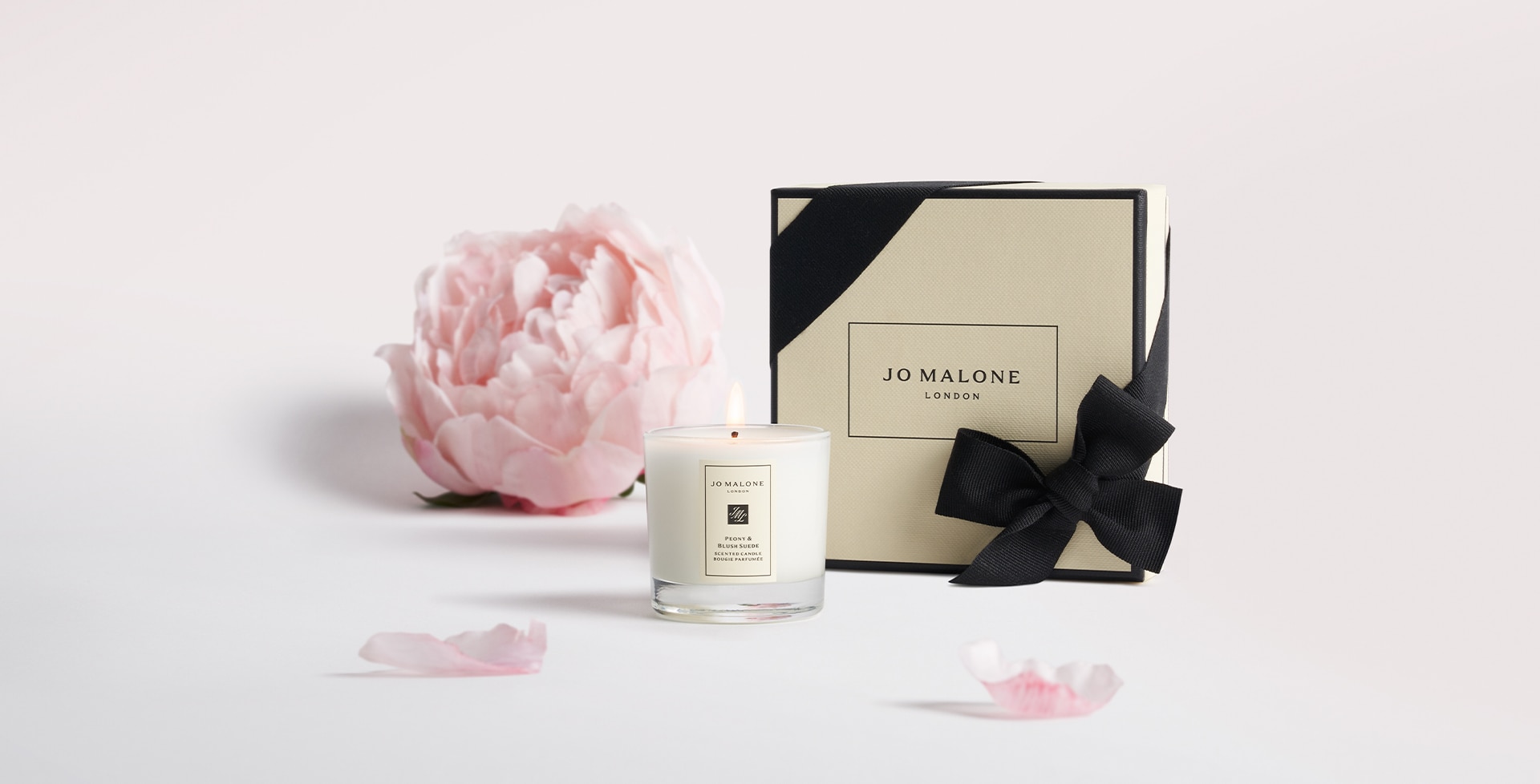 Jo Malone London mini peony blush suede candle with peony behind